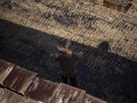 A young Afghan refugee boy looks on as he stands in a brick factory, in the Borkhar area in the west of the city of Isfahan 439Km (273 Miles...