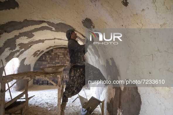 An Afghan refugee labor works in a brick factory, in the Borkhar area in the west of the city of Isfahan 439Km (273 Miles) southern Tehran o...