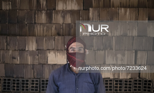 An Afghan refugee labor poses for a photograph while working in a brick factory, in the Borkhar area in the west of the city of Isfahan 439K...