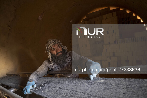 An Afghan refugee labor works in a brick factory, in the Borkhar area in the west of the city of Isfahan 439Km (273 Miles) southern Tehran o...