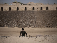 An Afghan refugee labor piles up bricks after removing them from a kiln in a brick factory, in the Borkhar area in the west of the city of I...