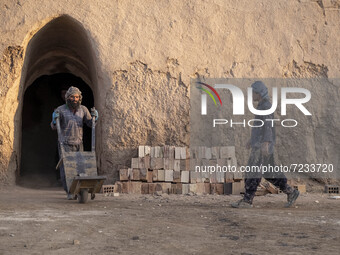 Two Afghan refugee laborers work in a brick factory, in the Borkhar area in the west of the city of Isfahan 439Km (273 Miles) southern Tehra...