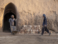 Two Afghan refugee laborers work in a brick factory, in the Borkhar area in the west of the city of Isfahan 439Km (273 Miles) southern Tehra...