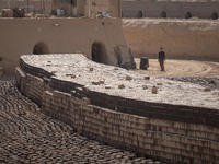 An Afghan refugee labor walks past newly bricks while working in a brick factory in the Borkhar area in the west of the city of Isfahan 439K...