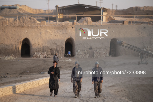 Afghan refugee laborers walk along an area in a brick factory after a working day in the Borkhar area in the west of the city of Isfahan 439...