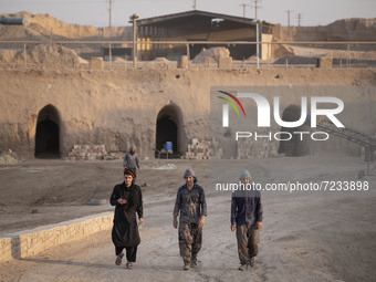 Afghan refugee laborers walk along an area in a brick factory after a working day in the Borkhar area in the west of the city of Isfahan 439...