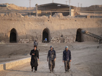 Afghan refugee laborers walk along an area in a brick factory after a working day in the Borkhar area in the west of the city of Isfahan 439...