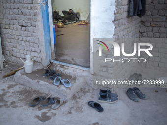 A Sunni-Afghan refugee labor rest at his hut which is shared with five other Afghan laborers in a brick factory after a working day in the B...