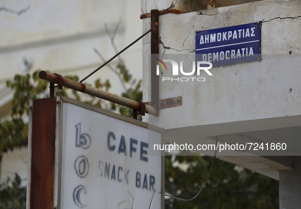 An old sign of the Cafe on Democracy Street on an abandoned building fenced off by the Turkish military since 1974 in the abandoned coastal...