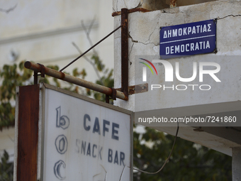 An old sign of the Cafe on Democracy Street on an abandoned building fenced off by the Turkish military since 1974 in the abandoned coastal...