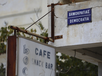 An old sign of the Cafe on Democracy Street on an abandoned building fenced off by the Turkish military since 1974 in the abandoned coastal...