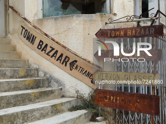 Old signs on abandoned buildings, fenced off by the Turkish military since 1974, in the abandoned coastal area of Varosha, a suburb of the c...