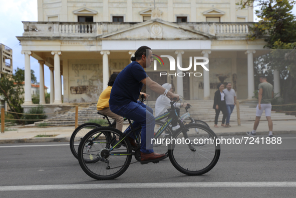 Tourists cycle through an area fenced in by the Turkish military since 1974 in the abandoned coastal area of Varosha, a suburb of the city o...