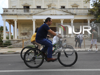 Tourists cycle through an area fenced in by the Turkish military since 1974 in the abandoned coastal area of Varosha, a suburb of the city o...