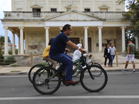 Tourists cycle through an area fenced in by the Turkish military since 1974 in the abandoned coastal area of Varosha, a suburb of the city o...