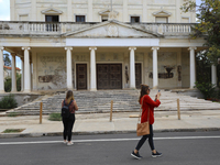 Women walk through territory fenced off by the Turkish military since 1974 in the abandoned coastal area of Varosha, a suburb of the city of...