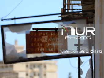 An old sign on an abandoned building, fenced off by the Turkish military since 1974, in the abandoned coastal area of Varosha, a suburb of t...