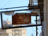 An old sign on an abandoned building, fenced off by the Turkish military since 1974, in the abandoned coastal area of Varosha, a suburb of t...