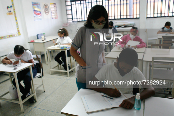 A teacher supervises a child during the start of face-to-face classes at all levels amid the Coronavirus pandemic in Caracas, Venezuela Octo...