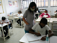 A teacher supervises a child during the start of face-to-face classes at all levels amid the Coronavirus pandemic in Caracas, Venezuela Octo...