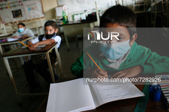 A boy looks at the blackboard during the start of face-to-face classes at all levels amidst the Coronavirus pandemic in Caracas, Venezuela O...