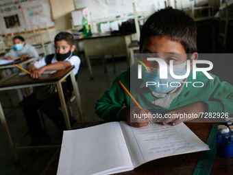 A boy looks at the blackboard during the start of face-to-face classes at all levels amidst the Coronavirus pandemic in Caracas, Venezuela O...