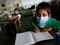 A boy looks at the blackboard during the start of face-to-face classes at all levels amidst the Coronavirus pandemic in Caracas, Venezuela O...