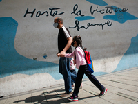 A man walks with a girl out of school during the start of on-site classes at all levels amid the Coronavirus pandemic in Caracas, Venezuela...