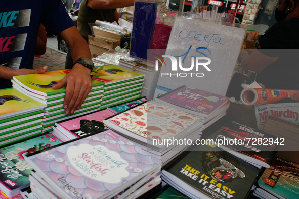 A vendor arranges notebooks at a school fair in the midst of the Coronavirus pandemic in Caracas, Venezuela October 25, 2021. 