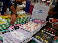 A vendor arranges notebooks at a school fair in the midst of the Coronavirus pandemic in Caracas, Venezuela October 25, 2021. (