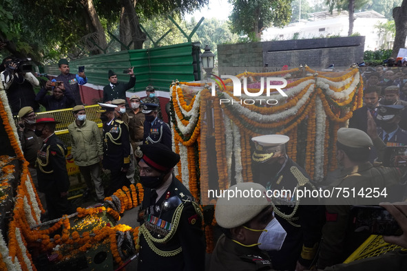 Officials and armed force personnel carry casket of India's Chief of Defence Staff General Bipin Rawat covered with flowers, who died in a h...