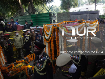 Officials and armed force personnel carry casket of India's Chief of Defence Staff General Bipin Rawat covered with flowers, who died in a h...