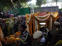 Officials and armed force personnel carry casket of India's Chief of Defence Staff General Bipin Rawat covered with flowers, who died in a h...