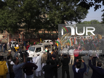 Officials and armed force personnel escort the vehicle covered with flowers carrying the casket of India's Chief of Defence Staff General Bi...