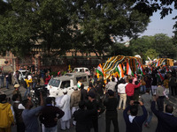 Officials and armed force personnel escort the vehicle covered with flowers carrying the casket of India's Chief of Defence Staff General Bi...