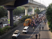 Officials and armed force personnel escort the vehicle covered with flowers carrying the casket of India's Chief of Defence Staff General Bi...