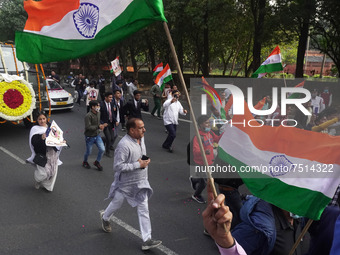 People participate as officials escort the vehicle covered with flowers carrying the casket of India's Chief of Defence Staff General Bipin...