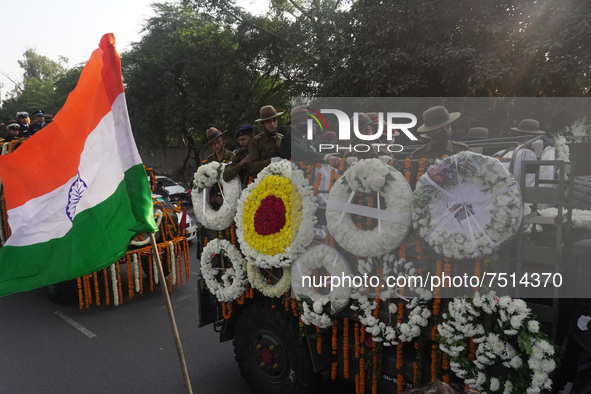 Soldiers are seen inside military truck as officials escort the vehicle covered with flowers carrying the casket of Madhulika Rawat, wife of...