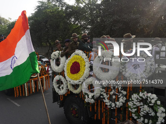 Soldiers are seen inside military truck as officials escort the vehicle covered with flowers carrying the casket of Madhulika Rawat, wife of...