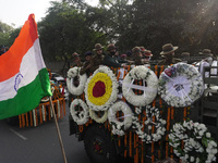 Soldiers are seen inside military truck as officials escort the vehicle covered with flowers carrying the casket of Madhulika Rawat, wife of...