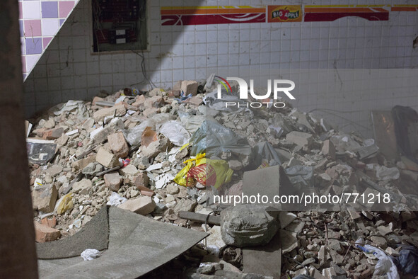 Rubble left over from breaking down walls in the building to make additional passages. 

 These families having been occupying buildings f...