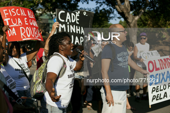 The families and activists came together for a protest in the streets of Rio de Janeiro. They marched around the area near the Olympic Headq...