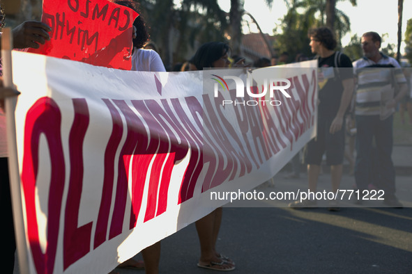 Favela family members and activists hold a banner reading "Olympics for whom?"

 These families having been occupying buildings for quite...