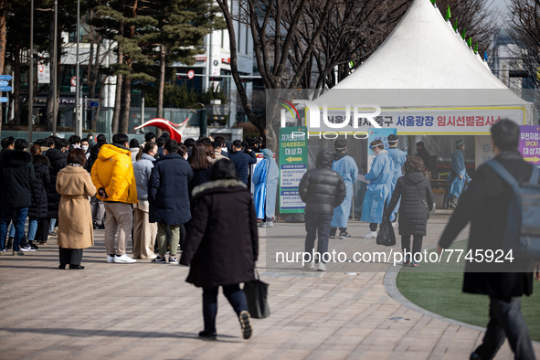 People wait in line at a COVID-19 testing facility at outside of the Seoul City Hall on February 9, 2022 in Seoul, South Korea. South Koreas...