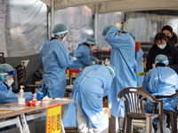 Citizens take a COVID-19 test at testing facility at Seoul Metropolitan Government Hall on February 9, 2022 in Seoul, South Korea. According...