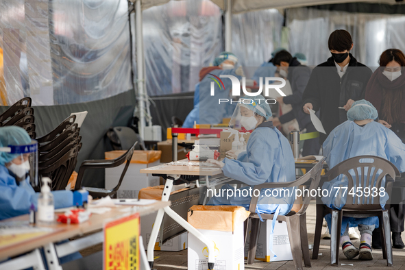 Medical workers test swab samples at a COVID-19 testing facility during the Omicron Variant wave of the Coronavirus pandemic on February 09,...