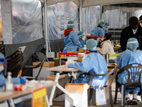 Citizens take a COVID-19 test at testing facility at Seoul Metropolitan Government Hall on February 9, 2022 in Seoul, South Korea. According...