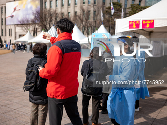 People wait in line at a COVID-19 testing facility at outside of the Seoul City Hall on February 9, 2022 in Seoul, South Korea. South Koreas...