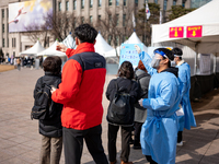 People wait in line at a COVID-19 testing facility at outside of the Seoul City Hall on February 9, 2022 in Seoul, South Korea. South Koreas...