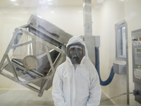 Laboratory technicians wearing full face masks and protective suits work to produce molnupiravir, the first tablet drug used to treat corona...